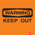 Orange background with black text reading 'WARNING' in a rectangular box above 'KEEP OUT' in bold letters, plus a small red pixel cluster in the bottom-right corner.