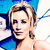 Pixelated portrait of a person with light brown hair wearing a blue top against a blue and white background.