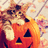 Pixelated image of a cartoon cat with orange fur and white chest, holding an orange pumpkin with black triangular eyes and mouth against a light background.