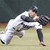 A baseball player in a white uniform with dark sleeves and cap is mid-pitch on a field, next to green text reading "Carl Crawford #13" above a large "TB" logo.