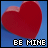 Two side-by-side animated frames of a red heart icon with "BE MINE" text on blue background, showing color variation between frames.