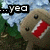 Pixelated image of a dinosaur-like creature with red mouth, black eyes, and white teeth against green foliage background.