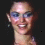 A four- shows a woman with blue eyeshadow smiling in the top two , a man in a suit in the bottom left, and pixelated text reading "SHE HAS TAHITI WRITTEN ALL OVER HER" in the bottom right