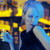 Pixelated image of a figure with blue hair and yellow accents against a dark background, rendered in low-resolution style.