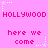 Pixelated pink background with repeated 'HOLLYWOOD' and 'here we come' text in bright pink, surrounded by white star outlines.