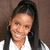 A pixelated image of a person with long dark hair wearing a white shirt, set against an orange and gray background with bold text overlays.