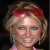 A pixelated image of a woman with blonde hair wearing a red headband and pink top, with the word 'Paris' in white text above her head.