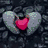A heart-shaped icon with a red center and gray wings on dark textured background.