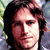 Two side-by-side pixelated images of a person with long brown hair against green foliage background, displayed as a contact sheet in 2x1 layout.