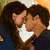 Animated sequence showing two figures in various poses: kissing, embracing, holding hands with an apple, and sitting together.