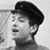 Black-and-white pixelated image of a person wearing a dark cap, viewed from the side with closed eyes and a neutral expression.