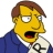 Pixelated yellow-skinned character with brown hair, blue jacket, white shirt, and black-and-white patterned tie, mouth open in mid-speech expression.