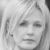 Static grayscale image of a person's face with short hair, neutral expression, and visible eyes, nose, mouth, and ear in close-up composition.