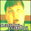 Pixelated close-up of a person with short green hair and green eyes, wearing a green shirt, with text overlay at bottom.