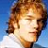 Pixelated static icon of a person with light brown hair against a blue background, wearing a white top.