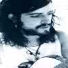 Static grayscale buddy icon of a person with long hair and beard wearing a necklace, cropped to show upper body against light background.