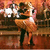 Two side-by-side frames from a pixelated animated icon showing a woman in a white dress dancing with a man in dark clothing against warm-toned and dark backgrounds.