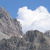 Pixelated landscape with rocky terrain under a blue sky and white clouds, rendered in low-resolution style.