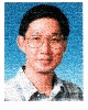 A person with short dark hair and glasses wears a light-colored collared shirt against a blue background, transitioning through cartoon overlays.