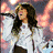 six red with pixelated text and two celebrity images, featuring a woman in white holding a microphone on the top-left
