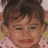 A pixelated image of a child with brown hair and pink clothing, accompanied by pink text reading "My Baby Cuz! How Cute Is Little Gianna?!?" on a light background.