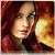 A woman with long red hair in a red hooded cloak appears in a of changing backgrounds including fire, ocean, and other figures