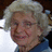 A pixelated image of a person with light-colored hair wearing a blue top, next to white text on a black background.