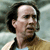 Pixelated close-up of a person with dark hair and a light-colored shirt against a blurred background.