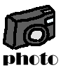 Gray digital camera icon with white lens and yellow flash, positioned above the word 'photo' in bold black text on a light gray background.