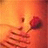 A pixelated static image shows a hand holding a red rose against an orange gradient background with scattered brown fragments.