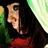 A person with long dark hair and a red top appears in four -aligned , each showing slight variations in head position against a green-and-white striped background