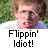 Pixelated image of a person with light brown hair and glasses, wearing white and blue clothing against green foliage background.