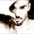 Pixelated static image of a person's face with dark hair and facial features rendered in brown, black, and white tones on a transparent background.