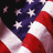 Static pixelated image of a stylized American flag with red and white stripes, blue field with white stars, and scattered star fragments against black background.