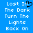 Blue background with white pixelated text reading 'Lost In The Dark Turn The Lights Back On' and a black heart symbol replacing the letter I in 'In'.