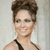Pixelated image of a person with short brown hair wearing a black halter top against a light gray background.