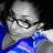 Pixelated grayscale portrait of a person with glasses and a blue garment, set against a dark background with blue and white accents.