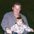 A pixelated image shows an adult holding a child against a dark background, with text elements surrounding the figures.
