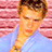 Static 48x48 pixel icon showing a person with short brown hair wearing a light blue shirt against a pink striped background, rendered in low-resolution pixel art style.
