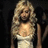 Pixelated image of a woman with long blonde hair in a white dress, next to blue pixelated text on a black background.