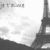 Pixelated grayscale image showing partial architectural structure with vertical and horizontal elements against light background.