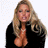 Static pixelated image of a woman with long blonde hair wearing a black top, visible chest area, and closed eyes against a white background.