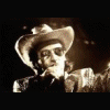 Animated sequence showing a person in various poses: wearing a cowboy hat and patterned jacket, singing into microphone with arm raised, green shirt with open mouth, white face paint with horns, dark clothing against red background.
