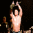 A shirtless muscular man with a cap holds a championship belt above his head in multiple poses against dark and blue backgrounds.