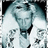 Pixelated image of a person in white clothing with dark accents, set against a gradient background transitioning from light to dark tones.