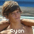 A pixelated image of a person with light brown hair and dark bangs, shirtless, standing against a beach background with blue water and sand, overlaid with white pixelated text.