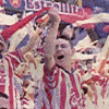 A crowd of people in red and white striped shirts cheer with raised arms and flags, some wearing blue accents, in a dense stadium scene.