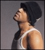 A static image of a person wearing a black beanie and white tank top, with text labels changing