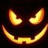 Pixelated pumpkin face with glowing orange eyes and mouth on black background, accompanied by blue pixel text phrases.