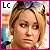 Two side-by-side animated frames of a pixelated cartoon-style icon showing a blonde woman with shoulder-length hair against a blurred background, each frame bordered by colored text "Lc" in the top-left corner.